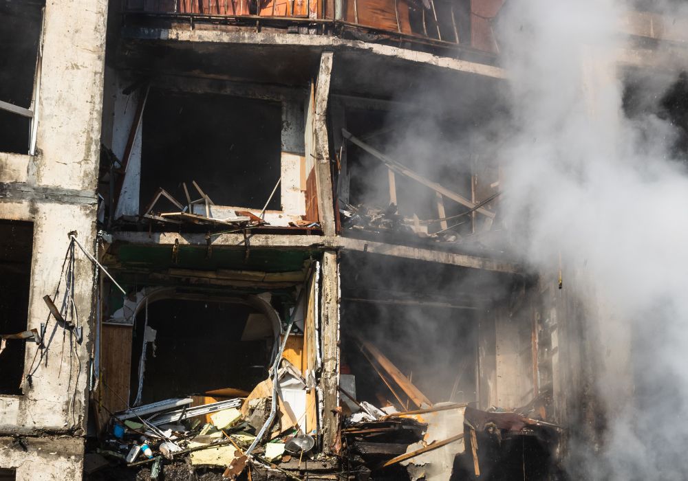 badly damaged residential building smoke from fire damage